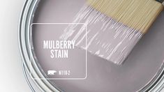 a paint can with a brush in it and the words mulberry stain on it