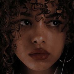 a close up of a person with curly hair