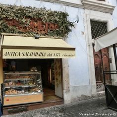 an outside view of a store with food on display