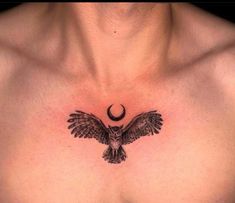 the chest is adorned with an owl and a crescent tattoo on it's chest