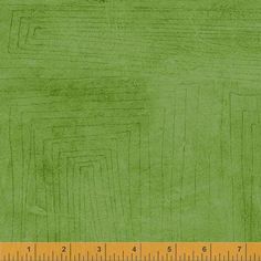 a ruler is next to a green background