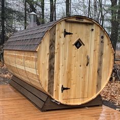 a wooden barrel sitting on top of a wooden deck