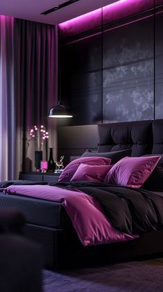 a bed with purple sheets and pillows in a dark room next to a large window