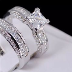 two white gold wedding rings with princess cut diamonds