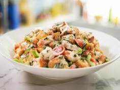 a white bowl filled with food on top of a table