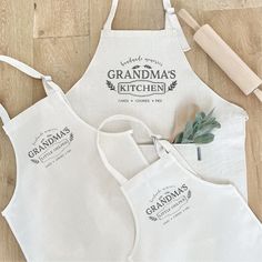 two aprons with the words grandma's kitchen on them next to a rolling pin