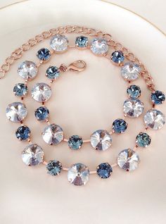 Gorgeous necklace featuring Swarovski crystals in various sizes and colors - - Dusty blue 12mm round crystals alternating with 8mm round crystals in denim and steel blue. The necklace is adjustable between 15 and 19 inches. Rose gold finished metal, as shown. Thanks for stopping by! Blue Crystal Necklace For Wedding, Blue Crystal Necklaces For Wedding, Blue Crystal Embellished Jewelry Gift, Blue Crystal Embellished Jewelry For Gift, Bracelet Display, Necklace Bridal, Swarovski Crystal Necklace, Necklace Display, Elegant Bracelet