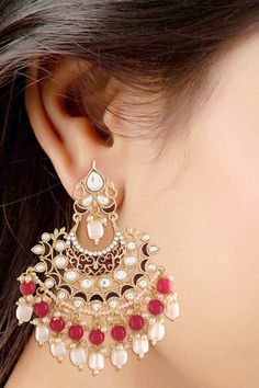 Product Features: Color: Maroon Base Metal: Alloy Work: Red Enamel Glided with Kundans and Pearls Plating Material: 18K Gold Plated Earring Dimension: L- 10 CM x W – 8 CM Occasion: Festive Disclaimer: There will be slight difference in digital to actual image Gold Chandbali Earrings, Gold Chandbali, Chandbali Earrings, Buy Buy, Red And Gold, Base Metal, Things To Buy, Product Features, Ear Cuff