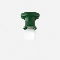 a green and white light fixture against a white background