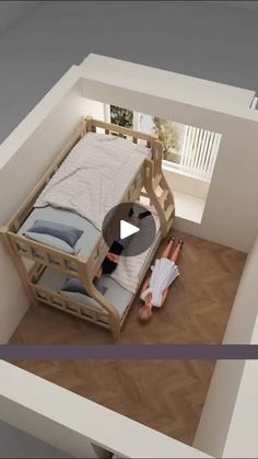 a person laying on top of a bed in a room with wooden floors and walls