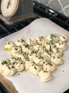 a bunch of food that is on top of a piece of paper in the oven