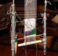 a close up of a weaving machine on a wooden floor