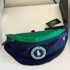 Exclusively Sold During The Us Open 2023. Green Crossbody Bag With Logo, Green Logo Crossbody Bag, Green Shoulder Bag With Logo For Daily Use, Green Shoulder Bag With Logo, Green Logo Shoulder Bag, Blue Shoulder Bag With Embroidered Logo For Travel, Blue Canvas Bag With Embroidered Logo, Blue Canvas Bags With Embroidered Logo, Green Everyday Bags With Logo