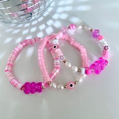 These 3 styles of pink bracelets are handmade and made to order with 0.5 mm elastic with a strong closure for more durability. Statement bracelet made with stainless steel, clay, genuine natural pearls and acrylic beads. This bracelet is perfect to wear on their own or stack with other colors and styles. Perfect as gifts for birthdays, Christmas, summer, valentine's day, easter or any occasion! we have different sizes available! Pink Flexible Beaded Bracelets For Gifts, Pink Beaded Bracelets For Gift, Pink Heishi Beads Beaded Bracelets, Adjustable Pink Pearl Bracelet With Spacer Beads, Pink Adjustable Pearl Stretch Bracelet, Adjustable Pink Pearl Stretch Bracelet, Handmade Flexible Pink Bracelets, Pink Pearl Bracelet With Letter Beads, Trendy Pink Hypoallergenic Bracelets