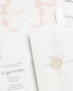 the wedding stationery is laid out on top of each other, including a ring