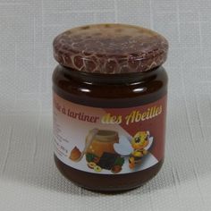 a jar of honey sitting on top of a table