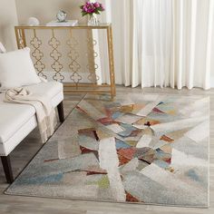 a living room area with a rug, chair and side table in front of a window