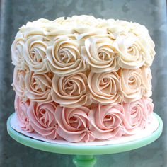 a close up of a cake with frosting roses on it's top and bottom