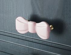 a close up of two pink handles on a cabinet