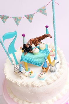 a birthday cake decorated with animals and decorations