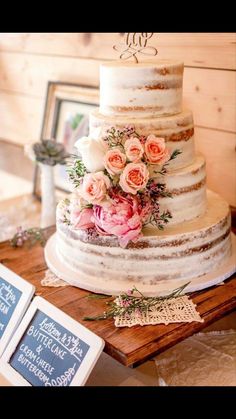 a white wedding cake with pink flowers on top