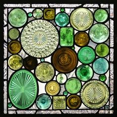 a stained glass window with many different colors and designs on it's sides, including circles