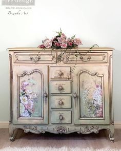 an old dresser with flowers painted on the doors and drawers is sitting in a room