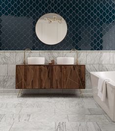 two white sinks sitting next to each other on top of a wooden cabinet in a bathroom