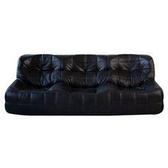 a black leather couch on a white background