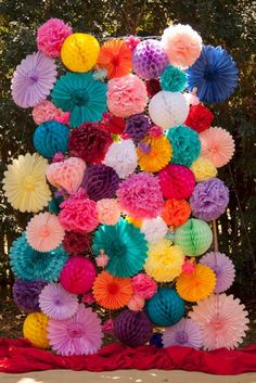 colorful paper flowers are arranged in the shape of a letter