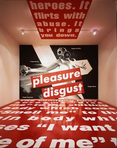 an art installation with red and white letters on the floor in front of a black and white background