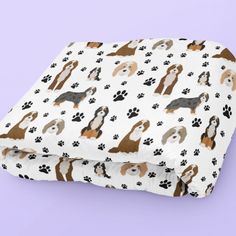 a blanket with dogs and paw prints on it