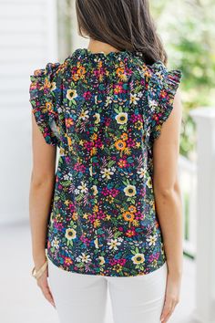 Meet your new favorite ditsy floral sleeveless blouse! This charming top pairs perfectly with shorts or jeans, making it ideal for so many different occasions. Its playful floral pattern and breezy design keep you looking stylish and feeling comfortable all day. Add this versatile piece to your wardrobe for an effortlessly chic summer look! Round neckline Button keyhole back Sleeveless cut Ruffled detailing Ditsy floral print No stretch Cindy is wearing the small. Cotton Ditsy Floral Print Summer Tops, Cotton Tops With Ditsy Floral Print For Summer, Summer Cotton Blouse With Ditsy Floral Print, Cotton Ditsy Floral Print Top For Day Out, Multicolor Ditsy Floral Print Cotton Tops, Vacation Floral Print Sleeveless Blouse, Black Floral Print Summer Blouse, Vacation Sleeveless Blouse With Floral Print, Sleeveless Floral Print Blouse For Vacation