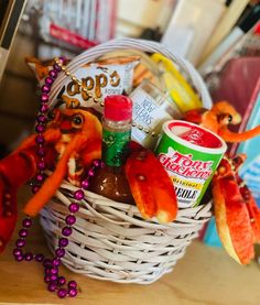 a basket filled with food and condiments on top of a wooden table next to other items