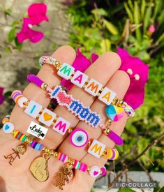 a person holding several different types of bracelets in their hand with the words i love mom written on them