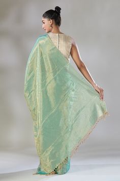 Green and gold handwoven zari tissue saree. Comes with a running blouse piece. - Aza Fashions Pista Green Cotton Silk Pre-draped Saree With Cutdana, Designer Pista Green Pre-draped Cotton Silk Saree, Pista Green Chanderi Pre-draped Saree, Unstitched Pista Green Cotton Silk Pre-draped Saree, Pista Green Cotton Silk Pre-draped Saree, Pista Green Anarkali Style Pre-draped Chanderi Saree, Gold Anarkali Style Cotton Silk Pre-draped Saree, Pista Green Art Silk Pre-draped Saree For Puja, Gold Cotton Silk Pre-draped Saree With Dupatta