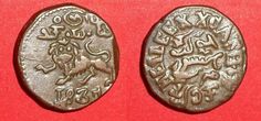 two ancient roman coins on a red surface