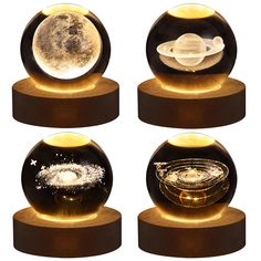 three glass globes with lights on each one and an image of the planets in them