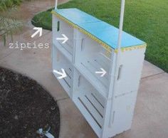 a white cart with blue top sitting on the side of a sidewalk next to grass