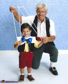 an older man and young boy are posing for the camera with strings attached to their hands