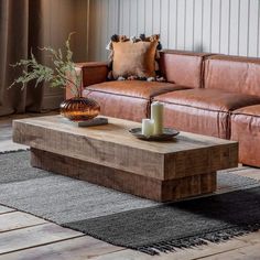 a living room with leather couches and a wooden coffee table