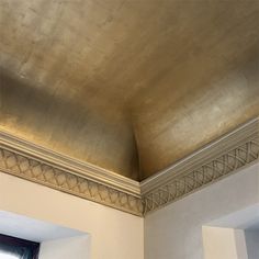 the ceiling is made of metal and has a decorative pattern on it's edge