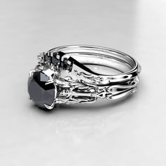 three silver rings with black diamonds on them