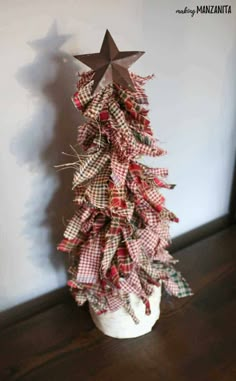 a small christmas tree made out of fabric