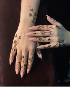 two hands with henna tattoos on them