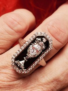 This is an absolutely amazing silver plate over brass with black enamel ring.  The enamel is painted around clear CZ stones in an urn motif.  You see this style in the 18th and 19th centuries usually as a memento mori or mourning ring.  Perfect for those who love historical pieces at an affordable price.  This ring reminds me of one that Marie Antoinette wore. It measures 1 inch tall by 1/2 inch wide and is so sparkly.  Limited stock at the moment.  Drop down has the sizes in stock.    If I do n Memento Mori Jewelry, Memento Mori Ring, Enamel Ring, Cz Ring, Memento Mori, Marie Antoinette, Limited Stock, Cz Stone, Black Enamel