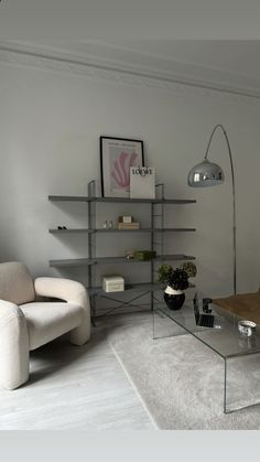 a living room filled with furniture and a glass table