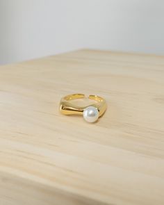 minimal open ring featuring single freshwater pearl with fluid band design yellow gold vermeil over 925 sterling silver freshwater pearl size 6.1mm in diameter high shine polished ring band open design total weight 2.43g Jewelry Minimal, Minimal Ring, Band Design, Jewelry Lookbook, Open Design, Open Ring, Pearl Size, Ring Band, Gold Vermeil