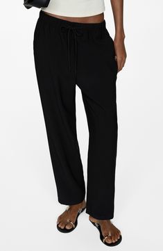 Look put-together but stay comfy in these flowy, high-rise, jogger-style trousers made with an elastic waist and relaxed straight legs. Elastic/drawstring waist Side slant pockets 93% viscose, 7% polyester Machine wash, line dry Imported Versatile Tapered Leg Harem Pants For Loungewear, Black Wide Leg Pants With Drawstring Relaxed Fit, Wide-leg Drawstring Harem Pants For Loungewear, Black Viscose Trousers, Black Wide Leg Pants With Drawstring And Relaxed Fit, Viscose Wide Leg Pants For Loungewear, Viscose Wide Leg Ankle-length Pants For Loungewear, Viscose Wide Leg Ankle-length Loungewear Pants, Ankle-length Viscose Wide Leg Loungewear Pants