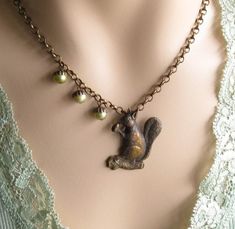 Step into a charming woodland world with our Vintage Style Squirrel Necklace.  This delightful piece captures the timeless appeal of nature and nostalgia.  Crafted with exquisite attention to detail, the squirrel necklace is a unique addition to your jewelry collection.   This necklace features a unique squirrel pendant with cute little acorn pearls one one side.  If you don't like the asymmetrical look, please let me know and I can add additional pearls to each side.   Want to customize this ne Squirrel Necklace, Woodland Jewelry, Acorn Necklace, A Squirrel, Mom Jewelry, Aunt Gifts, A Necklace, Squirrels, Cottage Chic